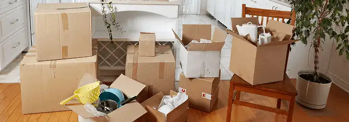 Packed moving boxes and household items in a kitchen before move-out or move-in cleaning, Tulsa, OK.